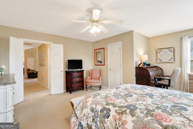 carpeted bedroom featuring visible vents, baseboards, and ceiling fan