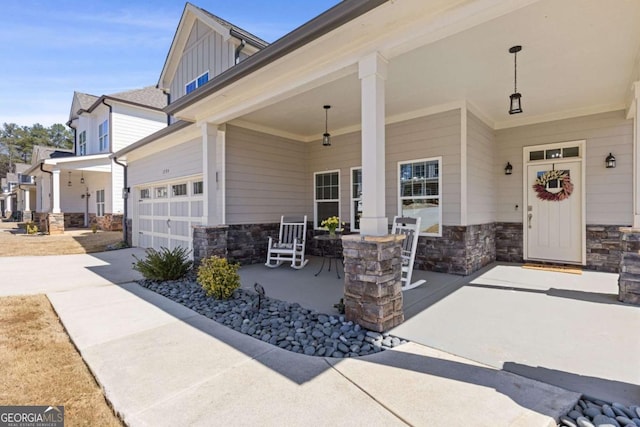 exterior space featuring board and batten siding, a porch, stone siding, and driveway