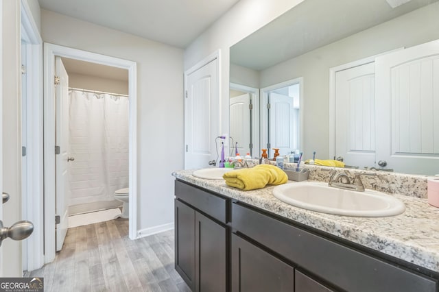 197 Stocks Cir, West Point, GA 31833 - full bath with double vanity, wood finished floors, toilet, and a sink