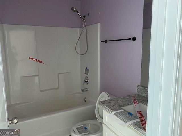 full bath featuring toilet, vanity, and shower / bathing tub combination