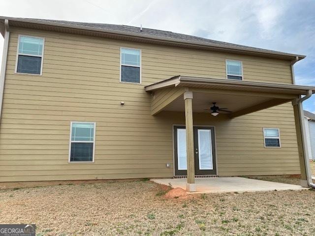 rear view of property with a patio area and ceiling fan