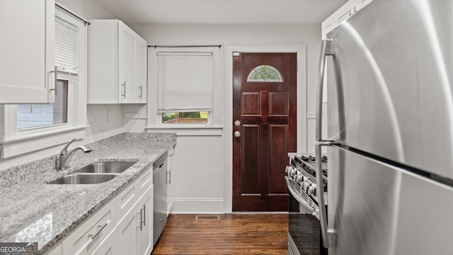 1132 Fair St SW, Atlanta, GA 30314 - kitchen with stainless steel appliances, a sink, dark wood-style floors, white cabinets, and light stone countertops