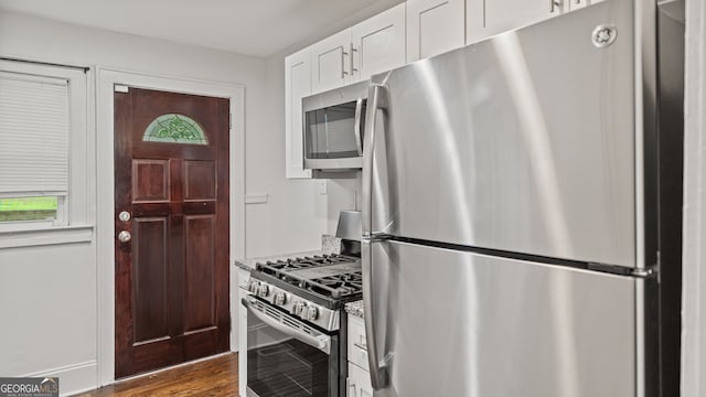 1132 Fair St SW, Atlanta, GA 30314 - kitchen with stainless steel appliances, white cabinetry, and dark wood-style floors
