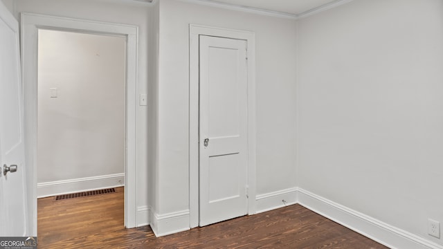 1132 Fair St SW, Atlanta, GA 30314 - unfurnished bedroom featuring dark wood finished floors, baseboards, and crown molding