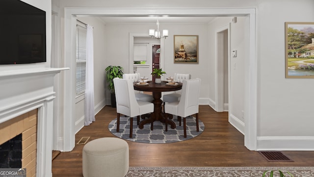 1132 Fair St SW, Atlanta, GA 30314 - dining room with dark wood finished floors, a chandelier, baseboards, and crown molding