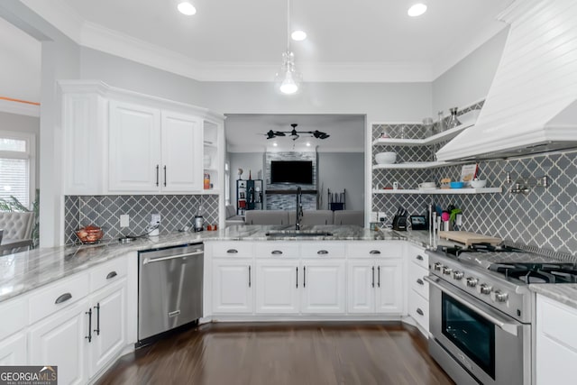 kitchen with open shelves, appliances with stainless steel finishes, crown molding, and a sink