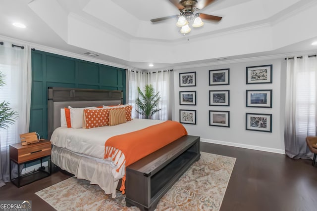 bedroom featuring baseboards, ornamental molding, recessed lighting, a raised ceiling, and dark wood-style flooring