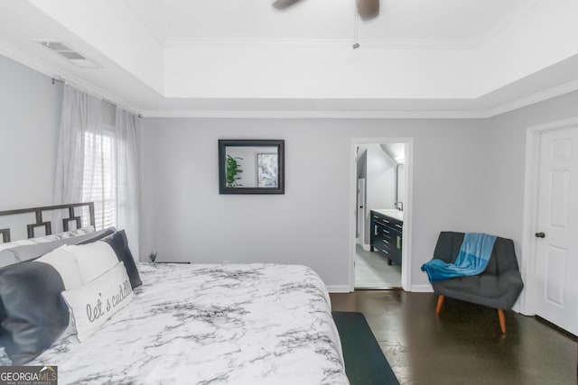 bedroom with visible vents, a raised ceiling, dark wood-style floors, and crown molding