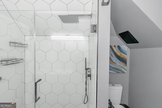 bathroom with toilet and a stall shower