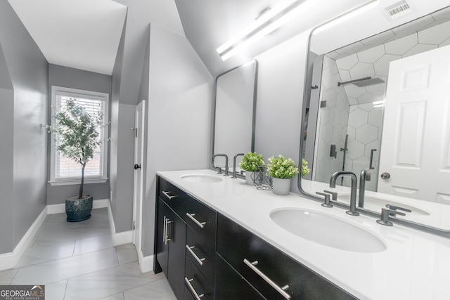 bathroom featuring a sink, visible vents, double vanity, and a shower stall