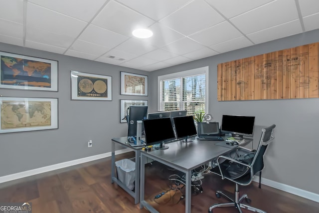 office featuring a drop ceiling, visible vents, baseboards, and wood finished floors