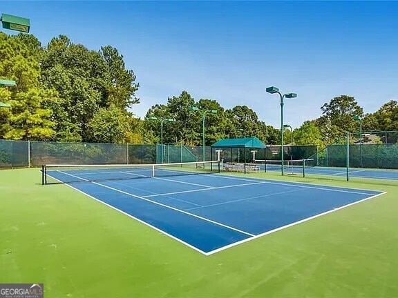 view of sport court featuring community basketball court and fence