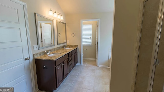 bathroom with a sink, baseboards, lofted ceiling, and toilet