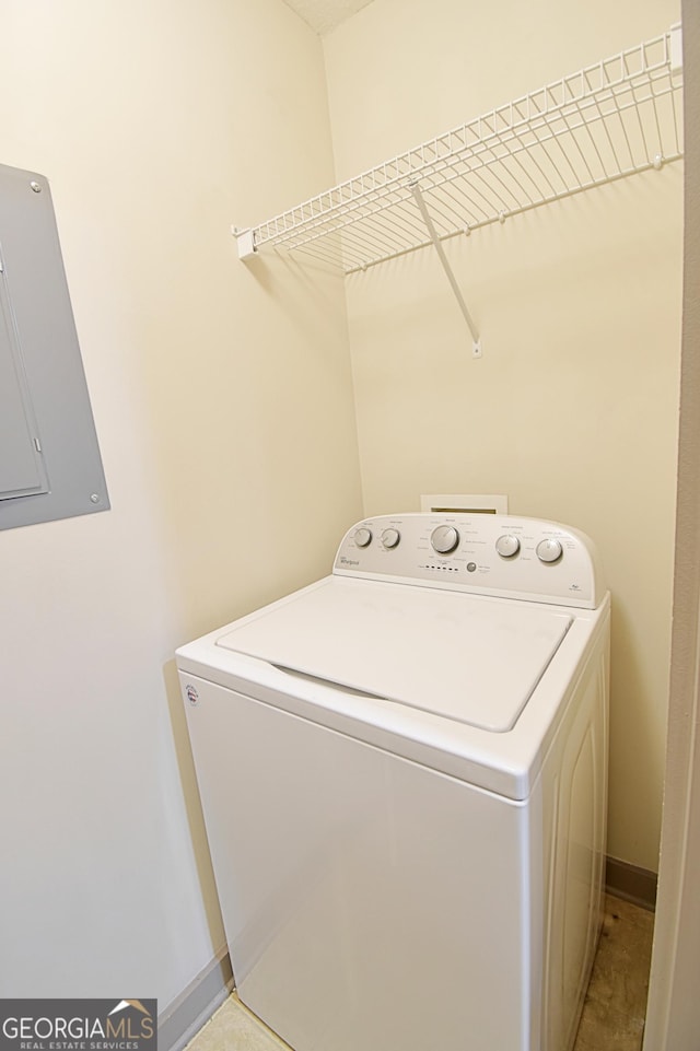 washroom with washer / dryer, electric panel, baseboards, and laundry area