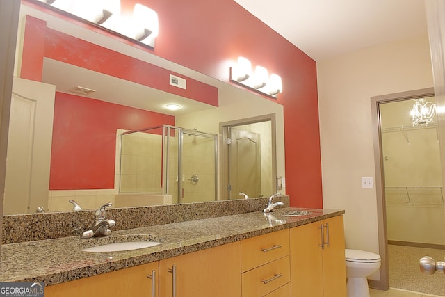 bathroom featuring a sink, visible vents, a stall shower, and double vanity