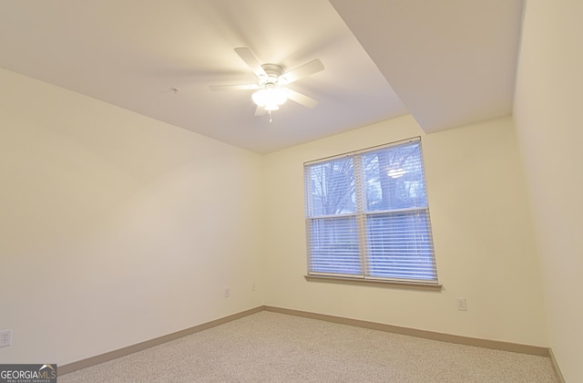 carpeted empty room with baseboards and ceiling fan