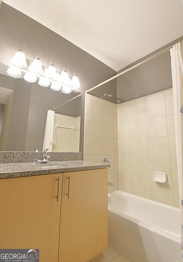 full bath featuring tile patterned floors, shower / bath combo, and vanity