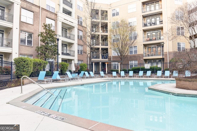 view of swimming pool with fence