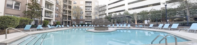 view of swimming pool featuring a patio area and fence