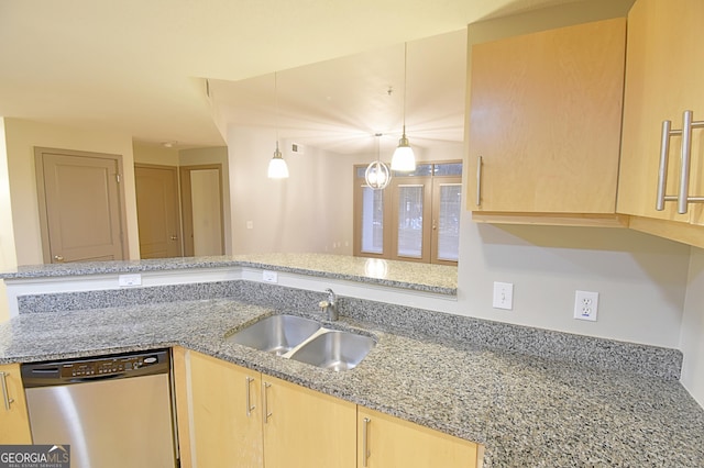 kitchen with light brown cabinets, decorative light fixtures, light stone counters, stainless steel dishwasher, and a sink