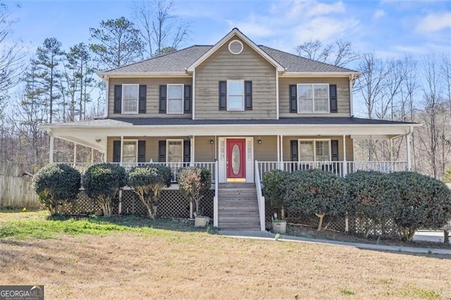 farmhouse featuring a porch and a front lawn