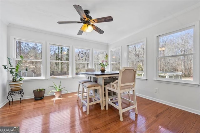 sunroom / solarium with a ceiling fan