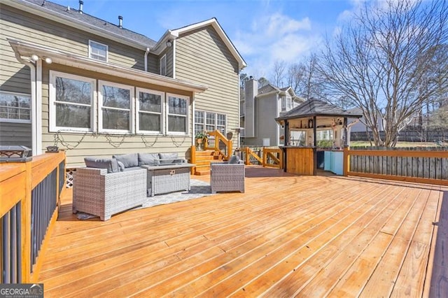 deck featuring a gazebo and an outdoor hangout area