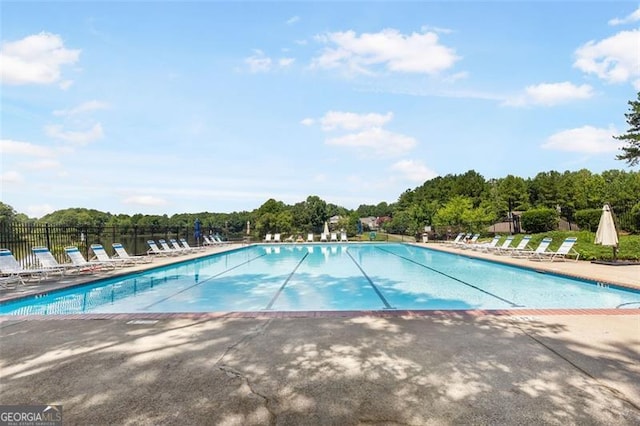 pool featuring a patio and fence