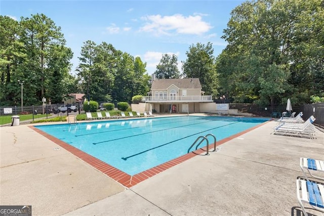 community pool featuring a patio and fence