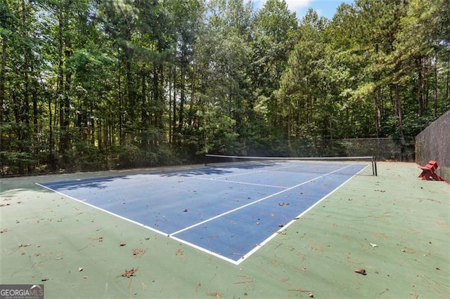 view of tennis court featuring fence