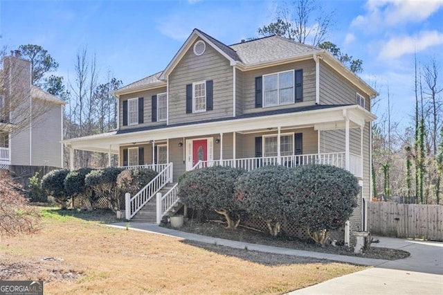 view of front of house featuring a porch and fence