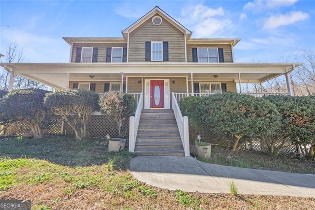 view of front of home featuring covered porch and stairs