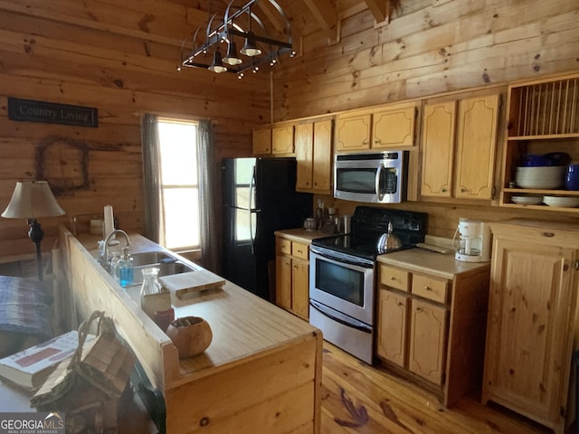 114 Palisade Dr, Ellijay, GA 30540 - kitchen featuring a sink, wooden walls, light countertops, and appliances with stainless steel finishes