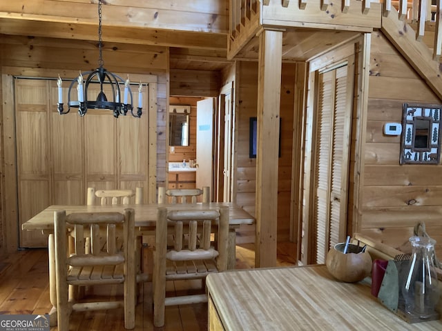 114 Palisade Dr, Ellijay, GA 30540 - dining space featuring wood walls, hardwood / wood-style flooring, and a chandelier