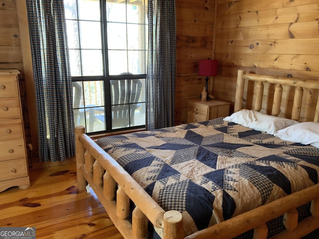 114 Palisade Dr, Ellijay, GA 30540 - bedroom featuring wooden walls and hardwood / wood-style floors