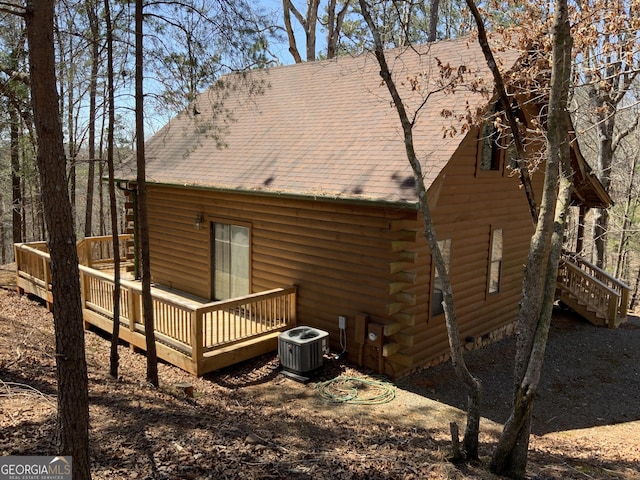 114 Palisade Dr, Ellijay, GA 30540 - back of property with log siding, a shingled roof, central air condition unit, and a wooden deck