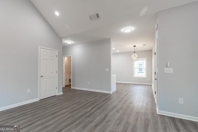 unfurnished room with recessed lighting, visible vents, baseboards, and dark wood-type flooring