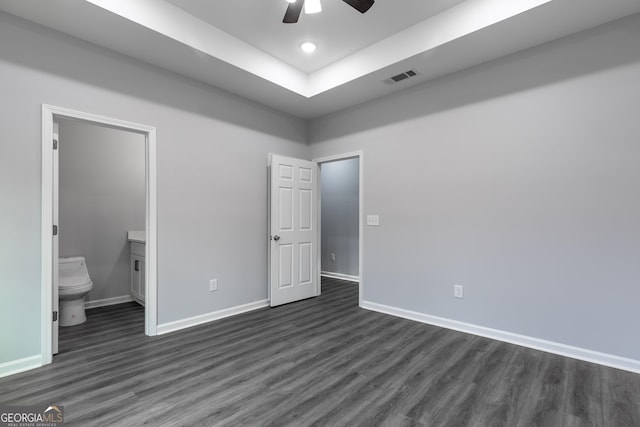 unfurnished bedroom with visible vents, dark wood-type flooring, and baseboards