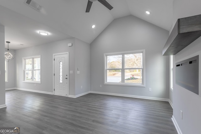 unfurnished living room featuring visible vents, baseboards, a ceiling fan, and dark wood-style flooring