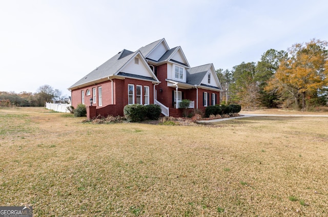 view of front facade featuring a front yard and brick siding