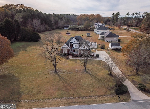 bird's eye view featuring a forest view and a rural view