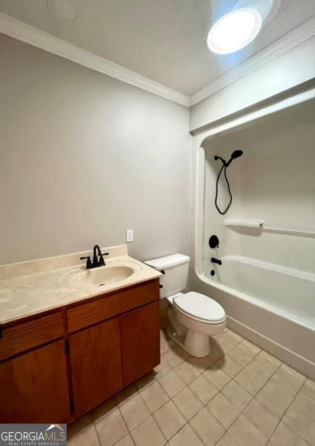 full bathroom featuring crown molding, washtub / shower combination, toilet, vanity, and tile patterned flooring