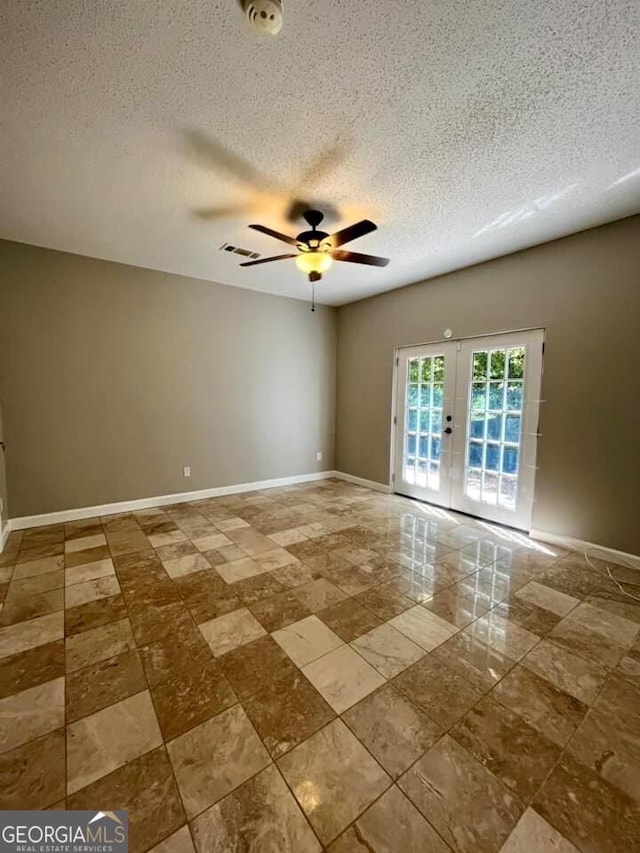 unfurnished room featuring french doors, baseboards, a textured ceiling, visible vents, and a ceiling fan