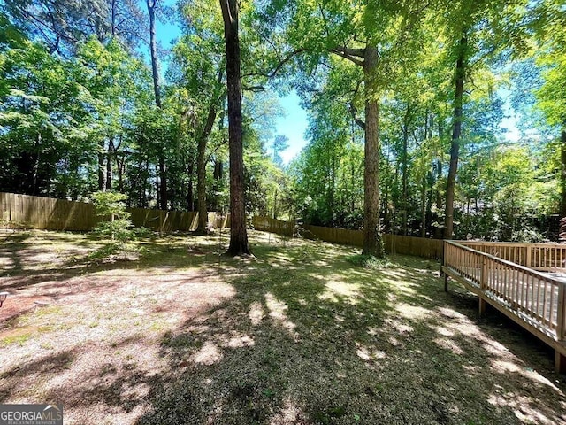 view of yard featuring a fenced backyard and a wooden deck