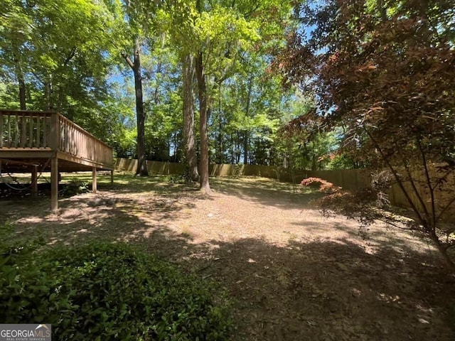 view of yard featuring a fenced backyard and a wooden deck