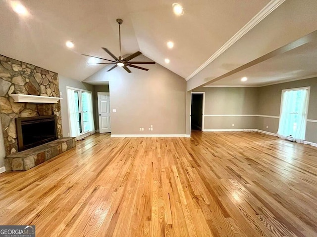 unfurnished living room with baseboards, light wood-type flooring, ceiling fan, and a fireplace