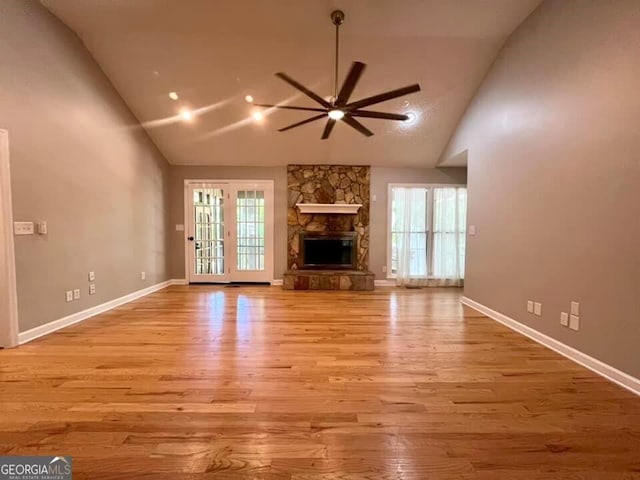 unfurnished living room featuring a ceiling fan, light wood-style floors, and a healthy amount of sunlight