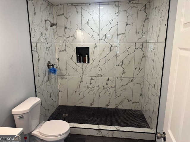 bathroom featuring a stall shower and toilet