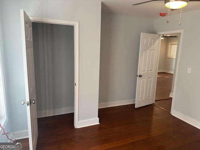 unfurnished bedroom featuring a ceiling fan, wood finished floors, and baseboards