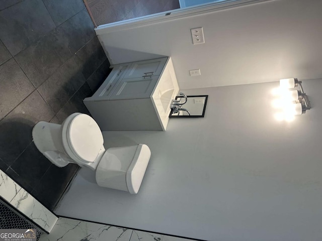 bathroom featuring toilet and marble finish floor